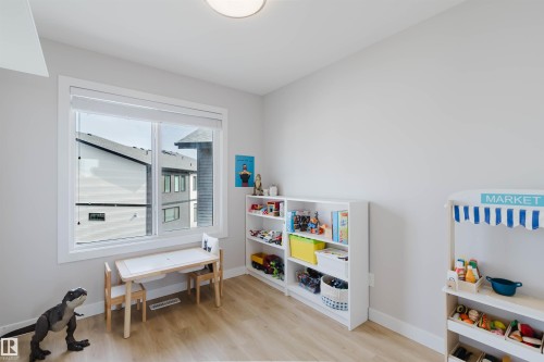 The room features light-toned flooring, a window with a white frame, and a flush mount ceiling light fixture - 1129 Keswick Drive, Edmonton, AB - Indoor