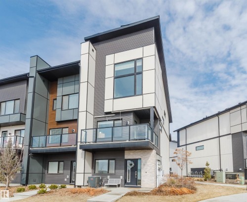 The property features a modern exterior with varied siding materials, including horizontal panels and vertical accents - 1129 Keswick Drive, Edmonton, AB - Outdoor With Balcony