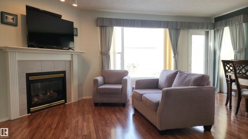 116 Maisonette Village, Leduc, AB - Indoor Photo Showing Living Room With Fireplace