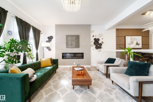The living space features light-toned flooring, a fireplace, and a decorative slatted wood accent wall - 22931 96 Avenue, Edmonton, AB - Indoor Photo Showing Living Room With Fireplace