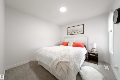This bedroom features light gray carpeting, a white bed frame, and a window providing natural light - 22931 96 Avenue, Edmonton, AB - Indoor Photo Showing Bedroom