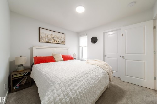 This room features light gray walls, a white paneled headboard, and gray carpet - 22931 96 Avenue, Edmonton, AB - Indoor Photo Showing Bedroom