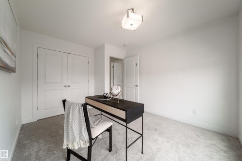 This room features light-colored carpeting, a ceiling-mounted light fixture, and white walls - 22931 96 Avenue, Edmonton, AB - Indoor
