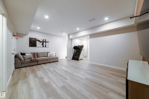Spacious room featuring light-toned flooring, recessed lighting, and white walls - 22931 96 Avenue, Edmonton, AB - Indoor