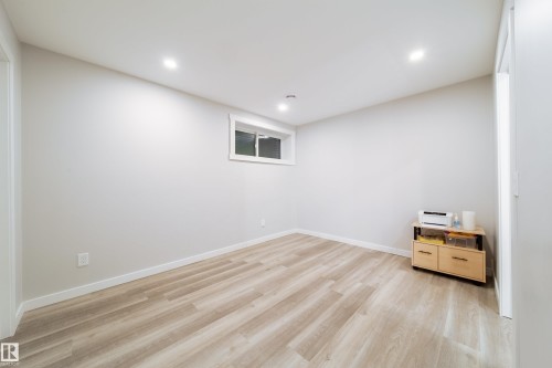 This room features light-colored flooring, recessed lighting, and a window with white trim - 22931 96 Avenue, Edmonton, AB - Indoor