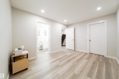This versatile room features light-toned plank flooring and recessed lighting - 22931 96 Avenue, Edmonton, AB - Indoor Photo Showing Other Room