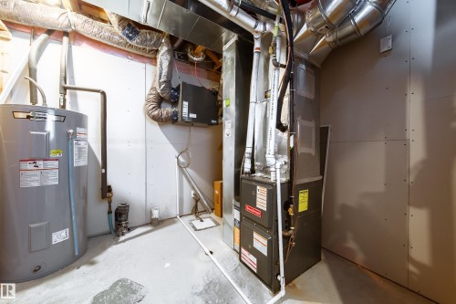 Utility room featuring a water heater and furnace unit - 22931 96 Avenue, Edmonton, AB - Indoor Photo Showing Basement