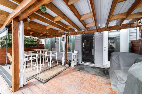 The property features a covered patio with exposed wooden beams, an exterior door, and a sliding glass door - 22931 96 Avenue, Edmonton, AB -  With Exterior