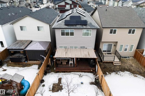 The property features a fenced yard, a rear deck, and solar panels installed on the roof - 22931 96 Avenue, Edmonton, AB - Outdoor With Deck Patio Veranda