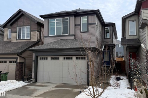 The property features a two-story exterior with grey siding and dark trim, accented by white-framed windows - 22931 96 Avenue, Edmonton, AB - Outdoor