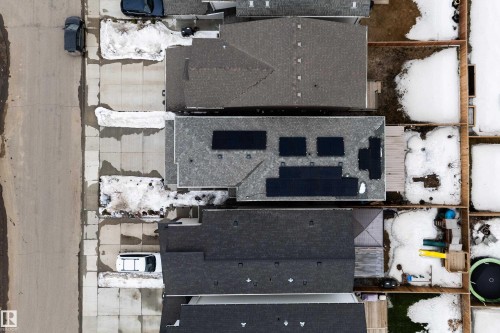 Aerial view showcasing the property's roof with solar panels, along with a concrete driveway and sidewalk - 22931 96 Avenue, Edmonton, AB - 