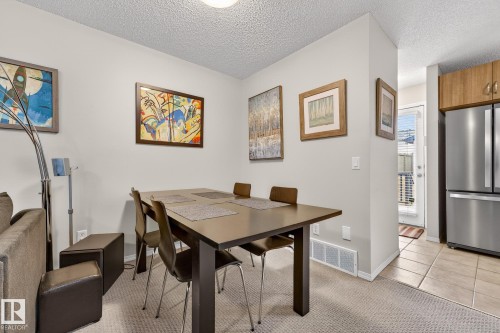 Dining area with carpeting and a modern dark wood table - 219 60 Street, Edmonton, AB - Indoor Photo Showing Dining Room