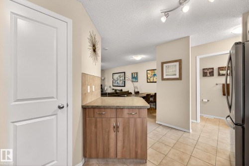 Entry area featuring light-colored walls, a white paneled door, and tiled flooring - 219 60 Street, Edmonton, AB - Indoor Photo Showing Other Room