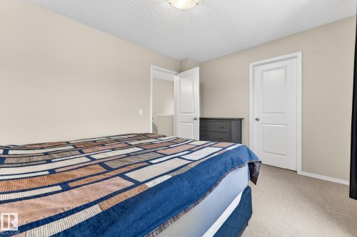 The room features light-colored walls, carpeted flooring, and white trim - 219 60 Street, Edmonton, AB - Indoor Photo Showing Bedroom
