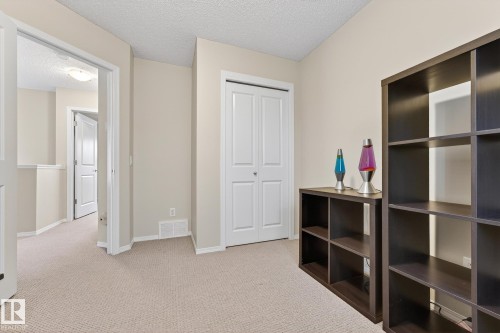 This area features neutral tone carpeting and light-colored walls, creating a versatile aesthetic - 219 60 Street, Edmonton, AB - Indoor