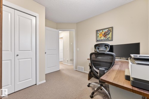 This room features neutral-toned carpet, light beige walls, and white trim - 219 60 Street, Edmonton, AB - Indoor Photo Showing Office