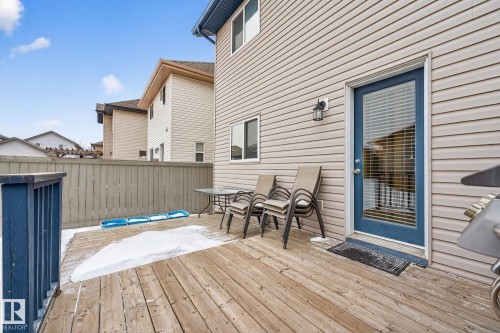 The property features an outdoor wooden deck, a privacy fence, and vinyl siding - 219 60 Street, Edmonton, AB - Outdoor With Deck Patio Veranda With Exterior