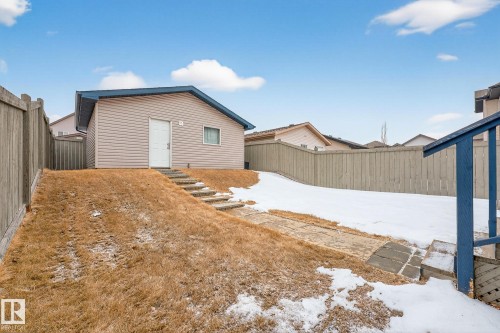 The property features a detached building with siding, a sloped roof, and a single entry door - 219 60 Street, Edmonton, AB - Outdoor With Exterior