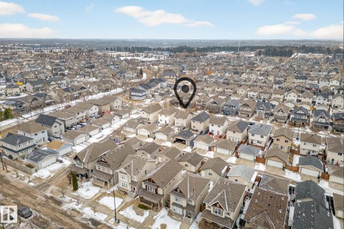 An aerial view of the property, surrounded by other residential properties, featuring a clear sky with scattered clouds - 219 60 Street, Edmonton, AB - Outdoor With View