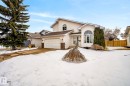 The property features a white exterior, an attached garage, and a driveway - 12815 156 Avenue, Edmonton, AB  - Outdoor With Facade 