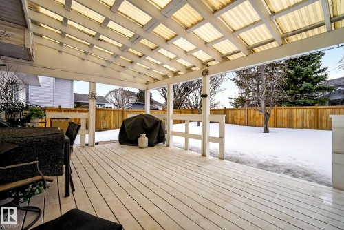 Expansive wooden deck with a translucent covered roof, providing an inviting outdoor living space - 12815 156 Avenue, Edmonton, AB - Outdoor With Deck Patio Veranda With Exterior
