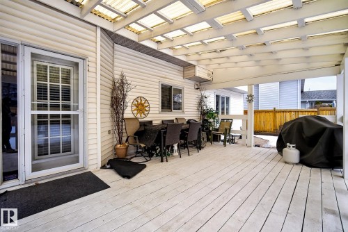 The property includes an expansive outdoor deck featuring a translucent roof covering - 12815 156 Avenue, Edmonton, AB - Outdoor With Deck Patio Veranda With Exterior