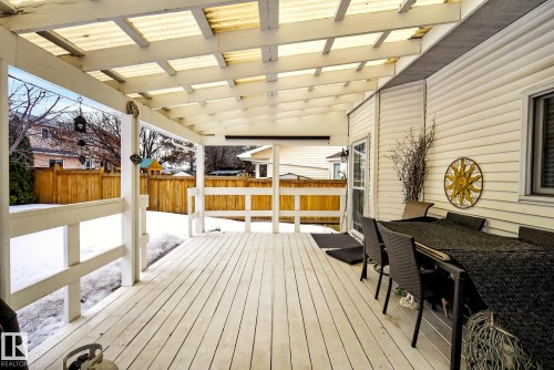 The property features a covered deck with white painted wood flooring and railings - 12815 156 Avenue, Edmonton, AB - Outdoor With Deck Patio Veranda With Exterior