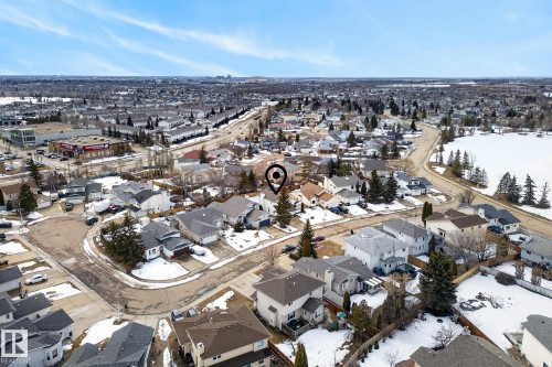 Aerial view showcasing the property within an established residential area, featuring a mix of detached homes with visible driveways and a street network - 12815 156 Avenue, Edmonton, AB - Outdoor With View