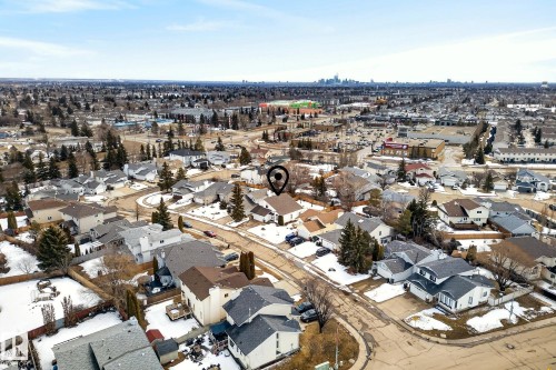 Aerial view of a residential neighborhood with detached properties, featuring a cityscape in the distance - 12815 156 Avenue, Edmonton, AB - Outdoor With View