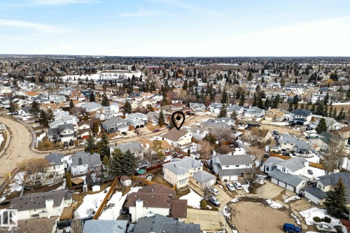 Aerial view showcasing the residential neighbourhood, featuring numerous houses with various roof styles and surrounding trees - 12815 156 Avenue, Edmonton, AB - Outdoor With View