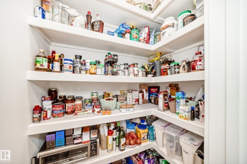 Well-organized pantry featuring extensive white shelving - 10936 117 Street, Edmonton, AB - Indoor With Storage
