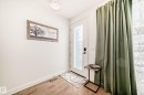 The entry features light-colored walls and wood flooring, complemented by a white door with frosted glass - 10936 117 Street, Edmonton, AB  - Indoor Photo Showing Other Room 