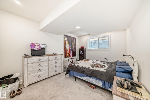 This room features white walls, recessed lighting, and a window with horizontal blinds - 10936 117 Street, Edmonton, AB - Indoor Photo Showing Bedroom