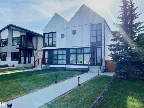 Modern architectural design featuring prominent gabled roofs and vertical white siding - 10936 117 Street, Edmonton, AB - Outdoor