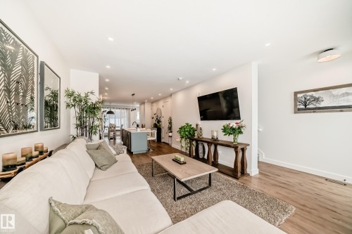 Spacious open concept living area featuring recessed lighting, hardwood floors, and bright white walls - 10936 117 Street, Edmonton, AB - Indoor Photo Showing Living Room