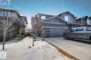 The property features a concrete driveway and an attached garage with a modern glass-paneled door - 6485 King Wynd, Edmonton, AB  - Outdoor With Facade 