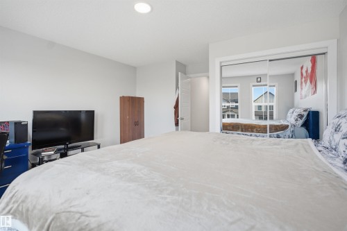 This room features a recessed ceiling light and a white paneled door - 7017 54 Avenue, Beaumont, AB - Indoor Photo Showing Bedroom