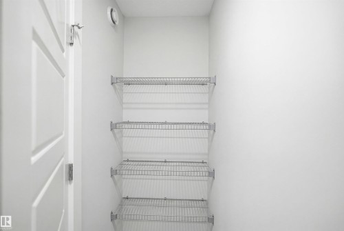 Storage area featuring four levels of wire shelving and light-colored walls - 7017 54 Avenue, Beaumont, AB - Indoor