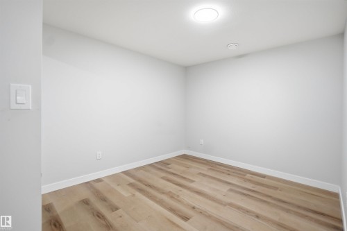 This room features light-colored walls, light wood-style flooring, and recessed ceiling lighting - 7017 54 Avenue, Beaumont, AB - Indoor Photo Showing Other Room
