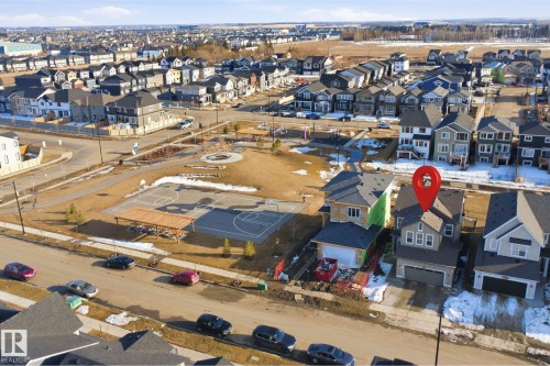 The property is located in a community featuring a basketball court and a park with open green spaces and walkways - 7017 54 Avenue, Beaumont, AB - Outdoor With View