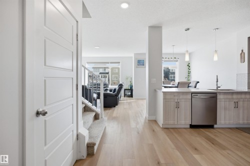 The property features light wood flooring and light-colored walls throughout - 7017 54 Avenue, Beaumont, AB - Indoor Photo Showing Kitchen With Upgraded Kitchen