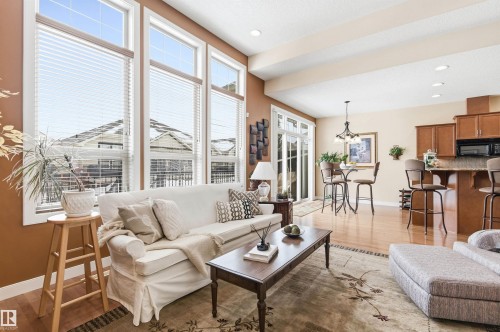 The bright living area features large windows, hardwood flooring, and recessed lighting - 13 841 156 Street, Edmonton, AB - Indoor Photo Showing Living Room