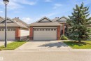 The property features a brick and siding exterior, an attached garage, and a concrete driveway - 13 841 156 Street, Edmonton, AB  - Outdoor With Facade 