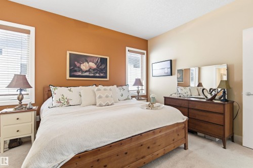 The property features a bedroom with a vaulted ceiling, light-colored carpeting, and windows with blinds - 13 841 156 Street, Edmonton, AB - Indoor Photo Showing Bedroom