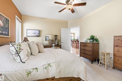 This room features carpeted flooring, a ceiling fan, and a light-colored wall with a window - 13 841 156 Street, Edmonton, AB - Indoor Photo Showing Bedroom