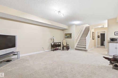 Spacious room featuring light-colored carpet, painted walls, and overhead lighting - 13 841 156 Street, Edmonton, AB - Indoor