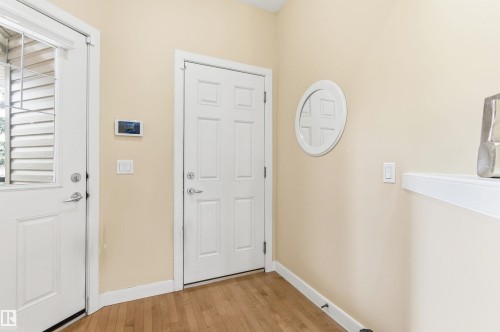 Entryway featuring hardwood floors, a white paneled door, and neutral-toned walls - 13 841 156 Street, Edmonton, AB - Indoor Photo Showing Other Room