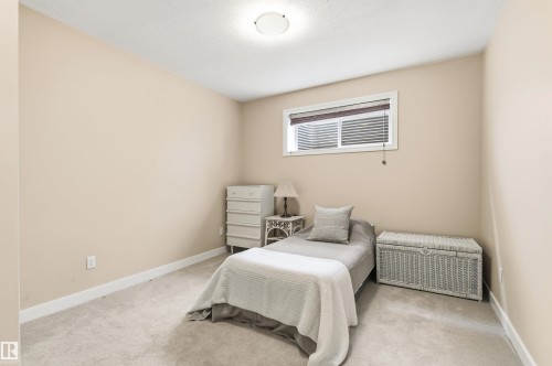 The room features neutral-toned walls, a white window frame with blinds, and light-colored carpeting - 13 841 156 Street, Edmonton, AB - Indoor Photo Showing Bedroom