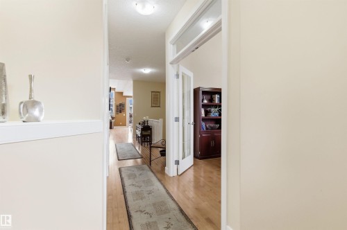 The property features hardwood floors and neutral-toned walls throughout - 13 841 156 Street, Edmonton, AB - Indoor Photo Showing Other Room