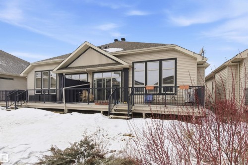 The property features a spacious deck with dark railings, providing an outdoor living area - 13 841 156 Street, Edmonton, AB - Outdoor